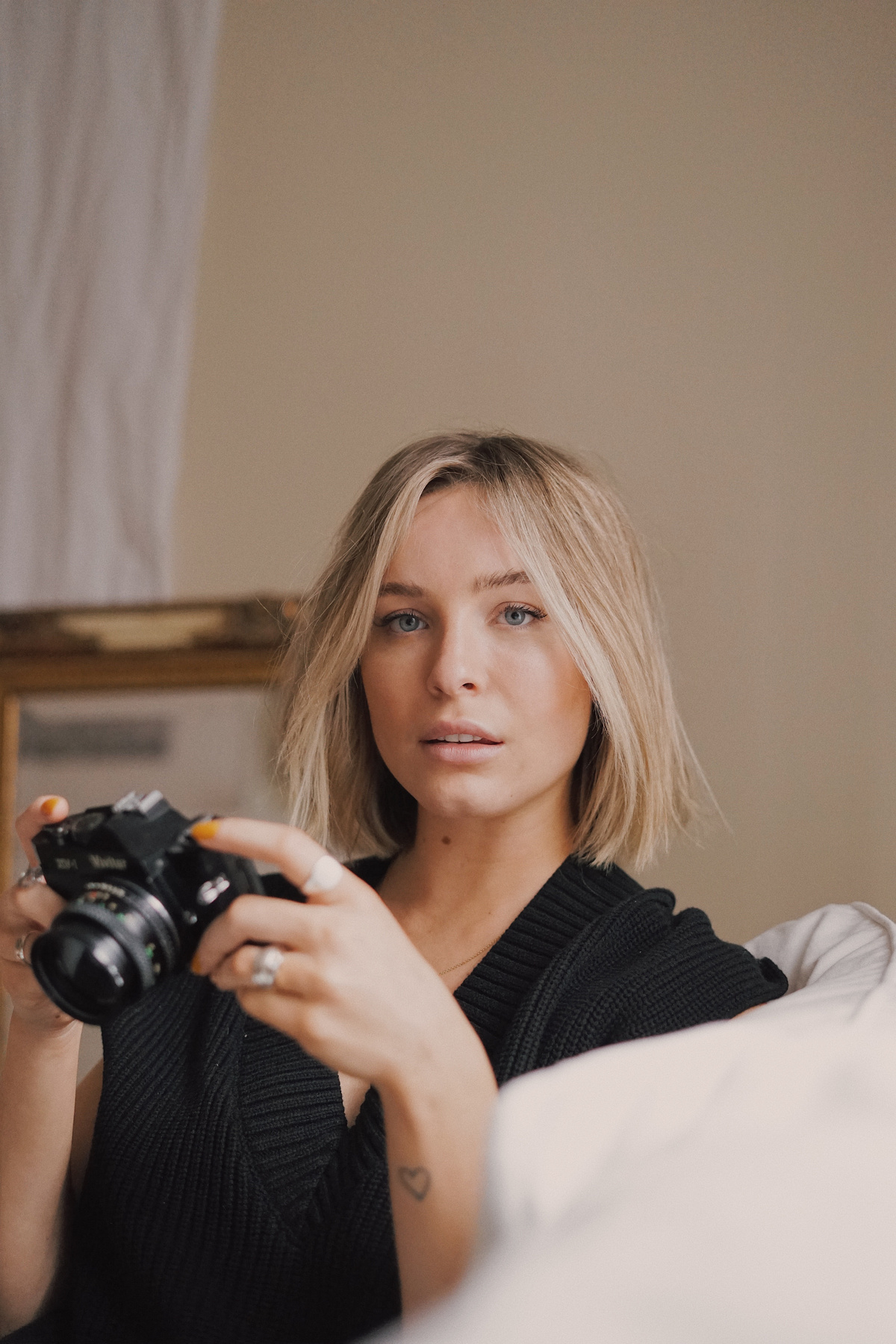 Blond Haired Woman Holding Camera